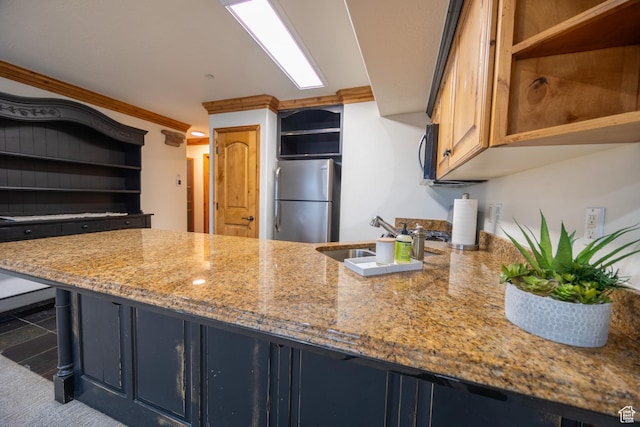 5063 E Lakeview Dr Unit 1009, Eden, UT 84310 - kitchen with light stone counters, ornamental molding, sink, and stainless steel refrigerator