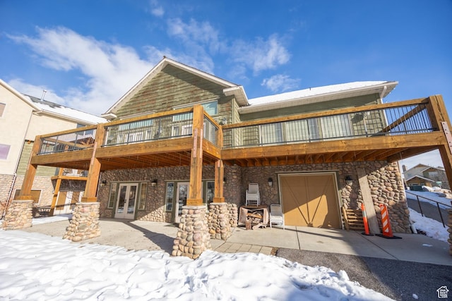 5063 E Lakeview Dr Unit 1009, Eden, UT 84310 - snow covered rear of property with a garage and french doors