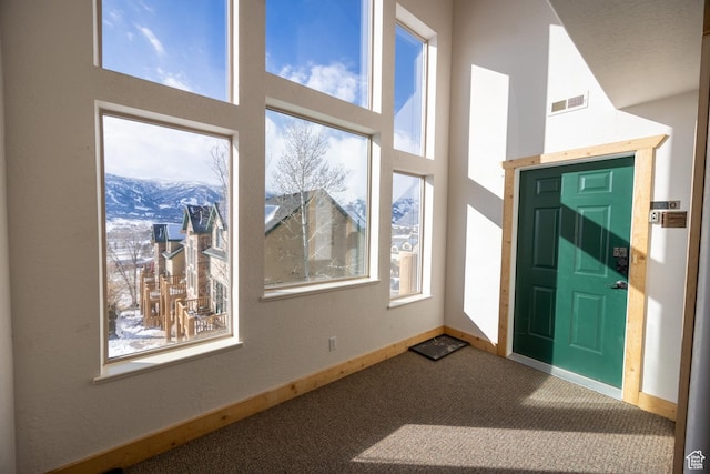 5063 E Lakeview Dr Unit 1009, Eden, UT 84310 - entryway featuring carpet flooring, a mountain view, a towering ceiling, and a healthy amount of sunlight