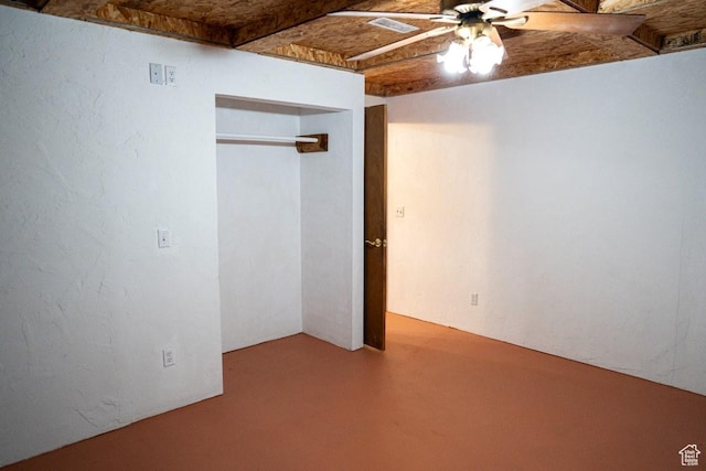 unfurnished bedroom with concrete flooring, a closet, and ceiling fan