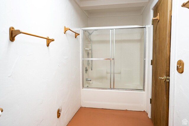bathroom featuring combined bath / shower with glass door