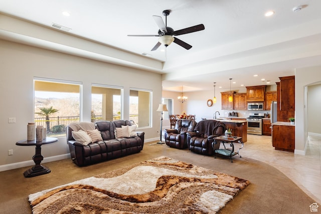 437 N Northstar Dr, St George, UT 84770 - living room featuring ceiling fan with notable chandelier and sink