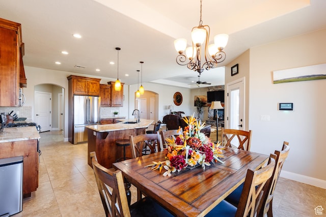 437 N Northstar Dr, St George, UT 84770 - dining room featuring sink, ceiling fan with notable chandelier, and light tile patterned flooring