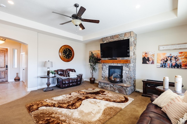 437 N Northstar Dr, St George, UT 84770 - carpeted living room featuring ceiling fan, a stone fireplace, and a raised ceiling