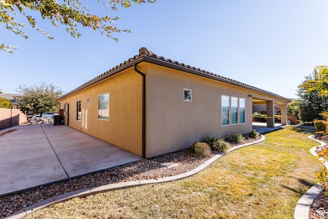 437 N Northstar Dr, St George, UT 84770 - view of side of home with a patio area and a lawn