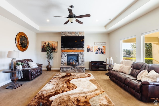 437 N Northstar Dr, St George, UT 84770 - carpeted living room featuring ceiling fan, a tray ceiling, and a stone fireplace