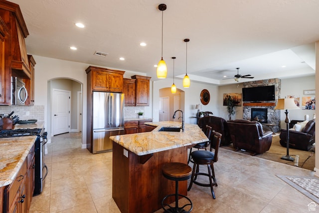 437 N Northstar Dr, St George, UT 84770 - kitchen featuring sink, a breakfast bar area, decorative light fixtures, stainless steel appliances, and a large island
