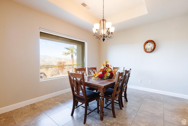437 N Northstar Dr, St George, UT 84770 - dining area with an inviting chandelier, tile patterned floors, and a tray ceiling