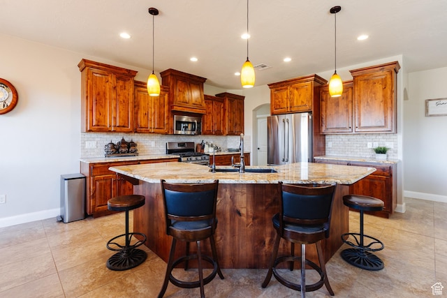 437 N Northstar Dr, St George, UT 84770 - kitchen with sink, a breakfast bar area, stainless steel appliances, and an island with sink