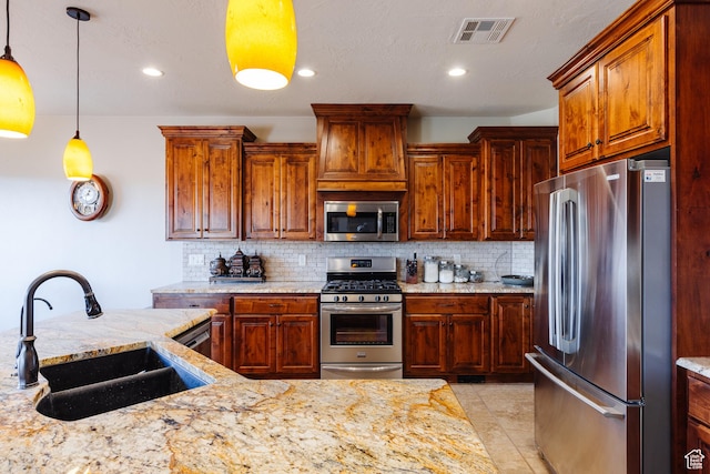 437 N Northstar Dr, St George, UT 84770 - kitchen featuring hanging light fixtures, light stone countertops, appliances with stainless steel finishes, and sink