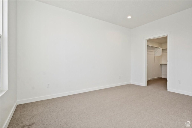7029 W S Jordan Pkwy Unit 380, South Jordan, UT 84009 - unfurnished bedroom with light colored carpet, a spacious closet, baseboards, recessed lighting, and a closet