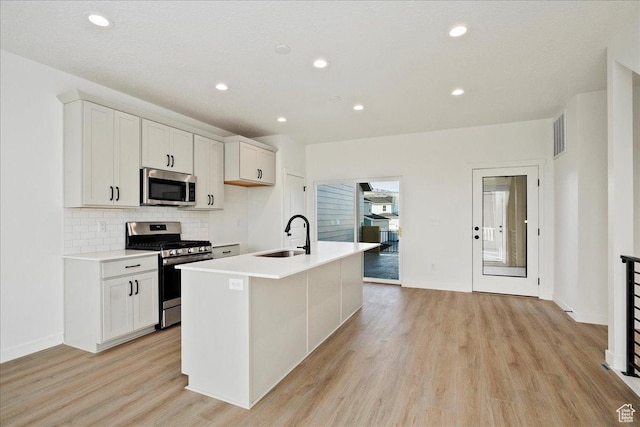 7029 W S Jordan Pkwy Unit 380, South Jordan, UT 84009 - kitchen with appliances with stainless steel finishes, a sink, light wood-style flooring, decorative backsplash, and recessed lighting