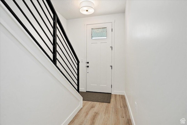 7029 W S Jordan Pkwy Unit 380, South Jordan, UT 84009 - entrance foyer featuring light wood-type flooring, stairs, and baseboards
