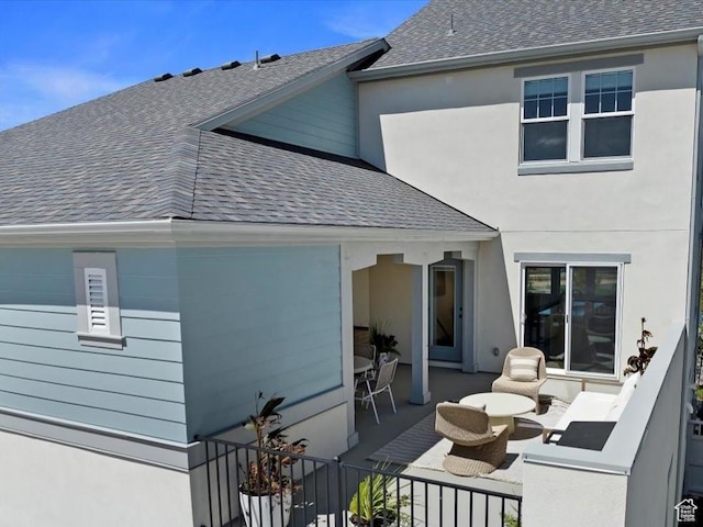 7029 W S Jordan Pkwy Unit 380, South Jordan, UT 84009 - back of property with a shingled roof, a patio, and stucco siding