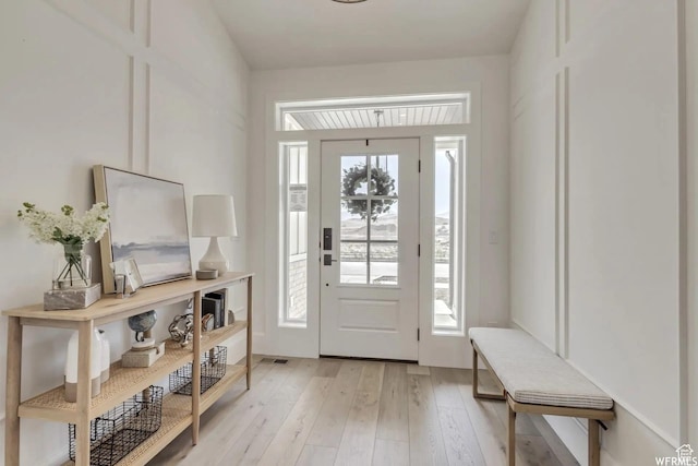 doorway to outside with light wood-style floors
