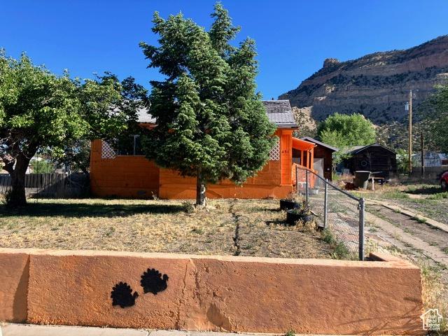 exterior space featuring a mountain view and fence