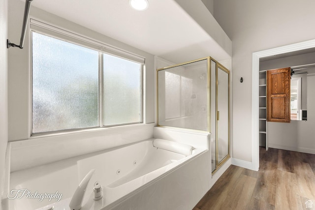 bathroom featuring hardwood / wood-style floors and independent shower and bath