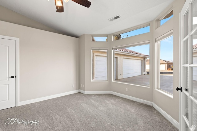 unfurnished room with carpet, ceiling fan, and vaulted ceiling