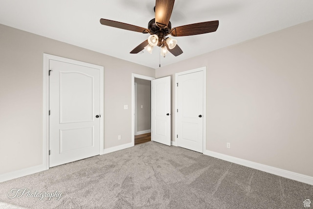 unfurnished bedroom featuring light colored carpet and ceiling fan