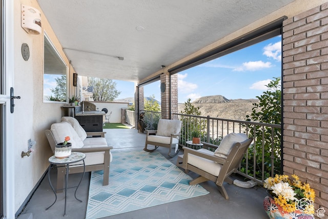 view of patio / terrace featuring a balcony and a mountain view