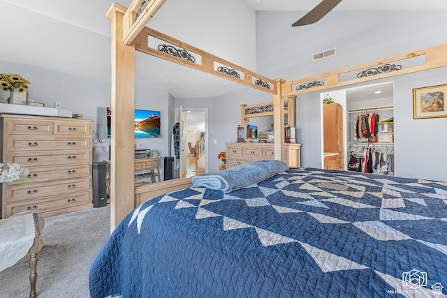 bedroom with visible vents, a closet, a spacious closet, carpet, and high vaulted ceiling
