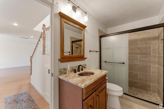631 N 380 W, La Verkin, UT 84745 - bathroom with vanity, a tile shower, toilet, wood finished floors, and recessed lighting