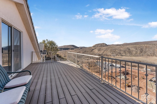 wooden deck with a mountain view