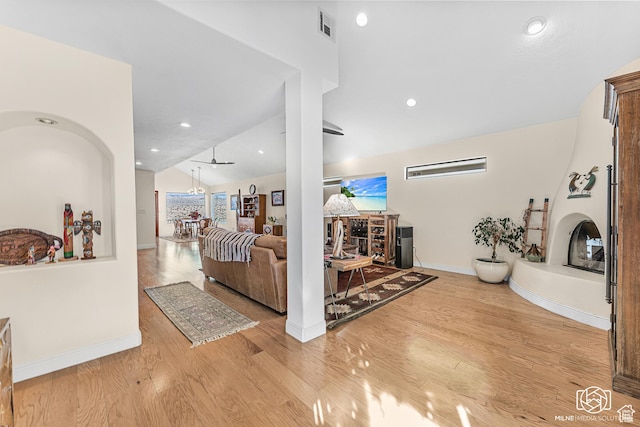 living area with visible vents, recessed lighting, wood finished floors, lofted ceiling, and baseboards