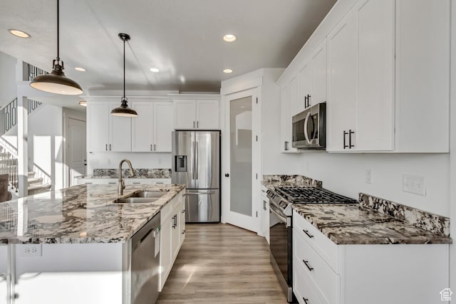 1153 W 1425th Dr N, Lehi, UT 84043 - kitchen featuring appliances with stainless steel finishes, a kitchen island with sink, sink, white cabinets, and hanging light fixtures
