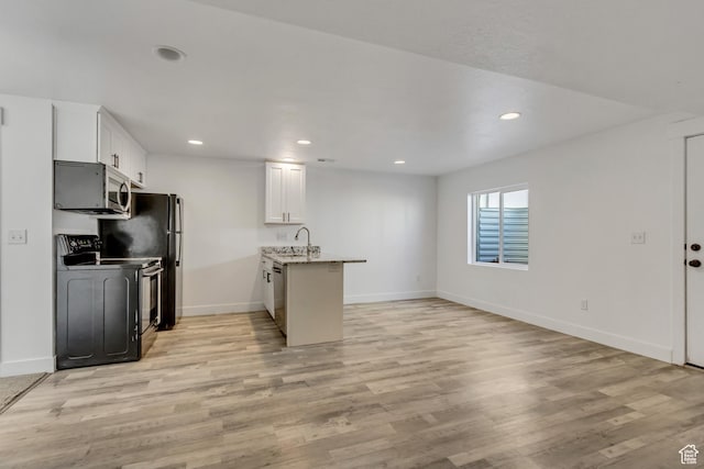 1153 W 1425th Dr N, Lehi, UT 84043 - kitchen with white cabinets, stove, light wood-type flooring, and kitchen peninsula