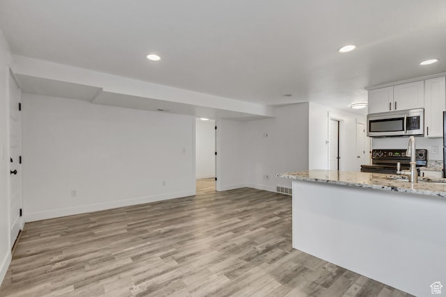 1153 W 1425th Dr N, Lehi, UT 84043 - kitchen with light stone counters, black range with electric cooktop, sink, light hardwood / wood-style flooring, and white cabinetry