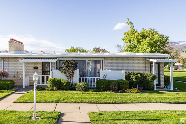395 W 400 N Unit 39, Bountiful, UT 84010 - single story home featuring brick siding, a chimney, and a front yard
