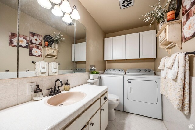 395 W 400 N Unit 39, Bountiful, UT 84010 - bathroom featuring decorative backsplash, visible vents, vanity, toilet, and washer and clothes dryer