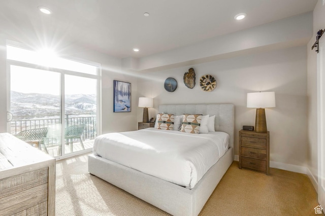 bedroom with access to outside, a mountain view, and carpet