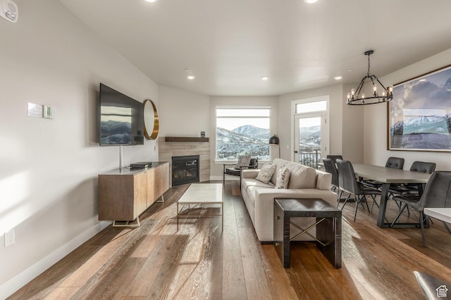 living room with wood-type flooring and a notable chandelier