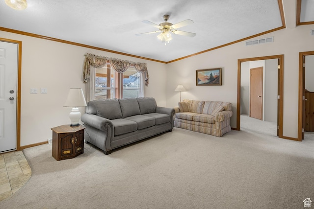 carpeted living room with ceiling fan, crown molding, and vaulted ceiling