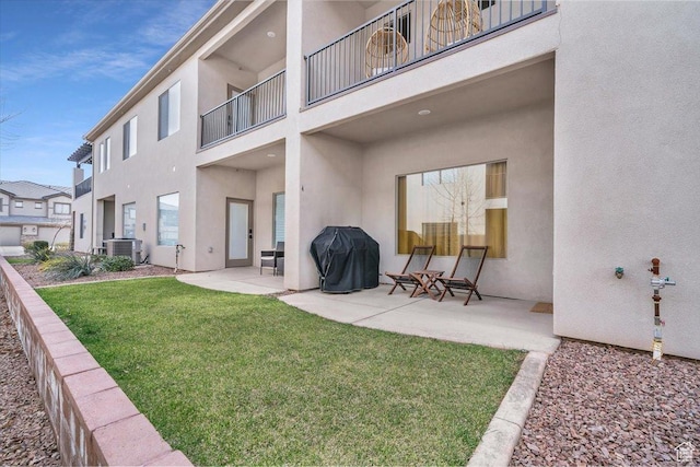 323 N 2020 W Unit 38, Hurricane, UT 84737 - back of house with a lawn, central AC, a balcony, and a patio