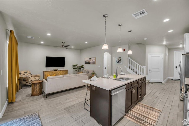 323 N 2020 W Unit 38, Hurricane, UT 84737 - kitchen featuring dark brown cabinets, ceiling fan, a kitchen island with sink, sink, and dishwasher