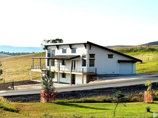 2584 S Country Club Dr Unit 12, Garden City, UT 84028 - rear view of property with a balcony, a yard, and a mountain view