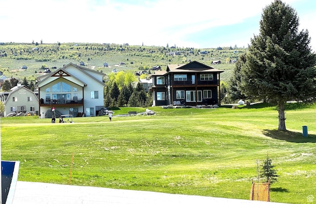 2584 S Country Club Dr Unit 12, Garden City, UT 84028 - view of grassy yard featuring a balcony
