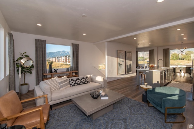 living area featuring a wealth of natural light, dark wood-style flooring, and recessed lighting