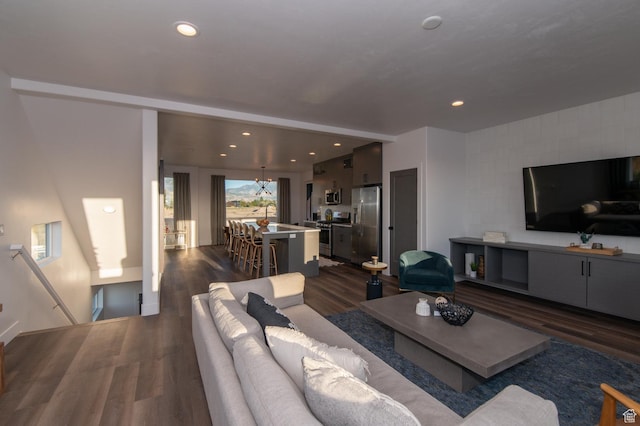 living room featuring recessed lighting and dark wood-style flooring