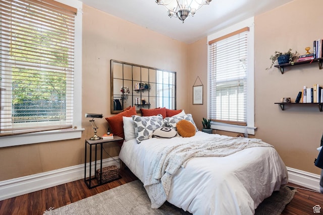 211 N 200 W, Salt Lake City, UT 84103 - bedroom featuring wood finished floors, a chandelier, and baseboard heating