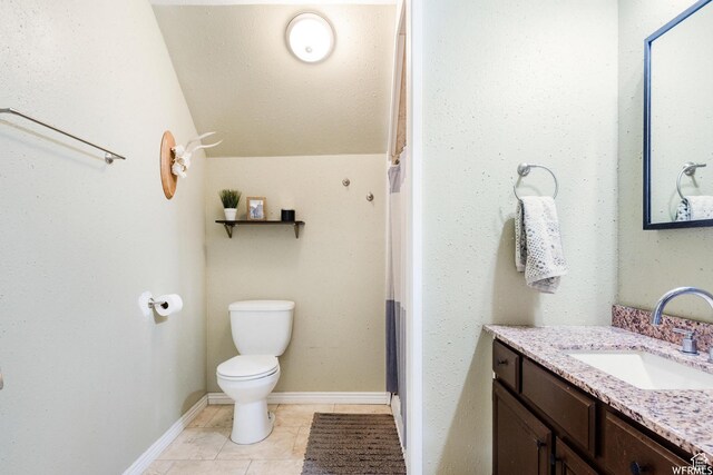 211 N 200 W, Salt Lake City, UT 84103 - bathroom with tile patterned floors, vanity, lofted ceiling, and toilet