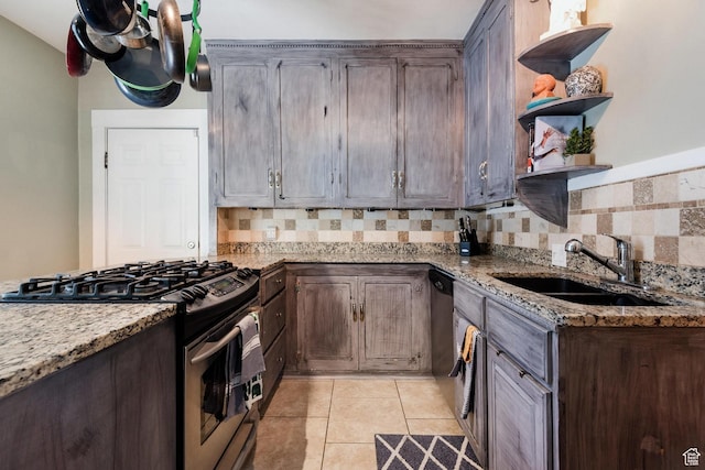 211 N 200 W, Salt Lake City, UT 84103 - kitchen featuring light stone counters, dark brown cabinetry, sink, light tile patterned floors, and stainless steel range with gas cooktop