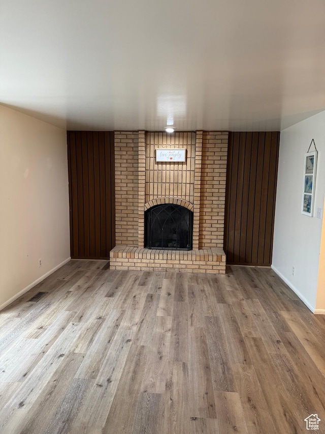 1316 S 200 W Unit 14, Bountiful, UT 84010 - unfurnished living room with a fireplace, visible vents, baseboards, and wood finished floors