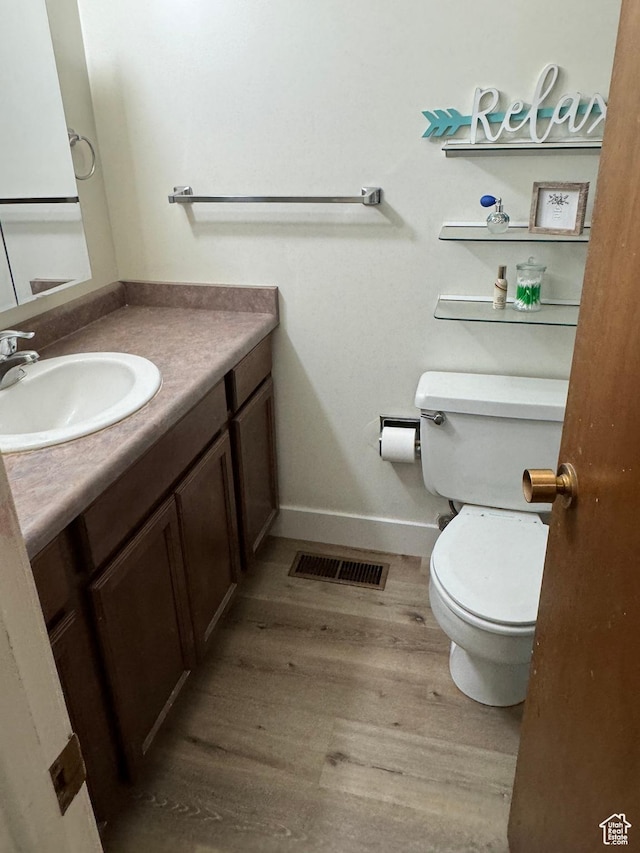 1316 S 200 W Unit 14, Bountiful, UT 84010 - bathroom featuring visible vents, baseboards, toilet, vanity, and wood finished floors