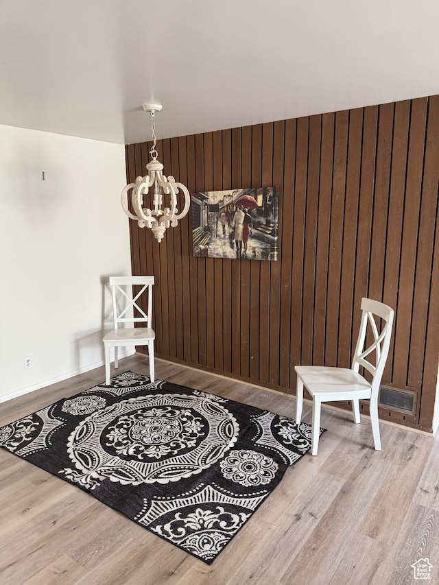 1316 S 200 W Unit 14, Bountiful, UT 84010 - dining space with a chandelier, wooden walls, and wood finished floors