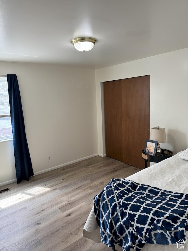 1316 S 200 W Unit 14, Bountiful, UT 84010 - bedroom featuring visible vents, a closet, baseboards, and light wood-style flooring