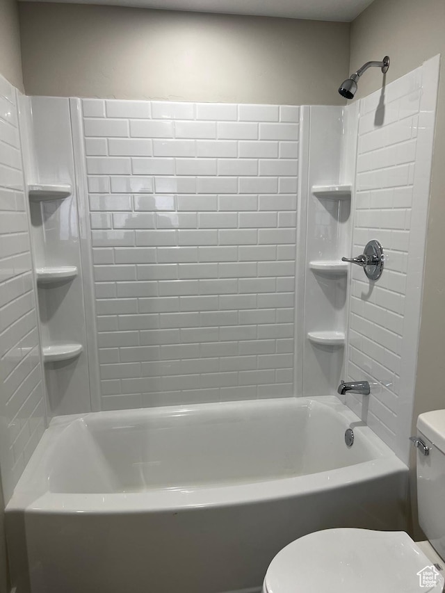 bathroom with shower / bathing tub combination and toilet